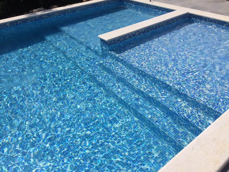 Before and after concrete pool renovation with new tiles and coping